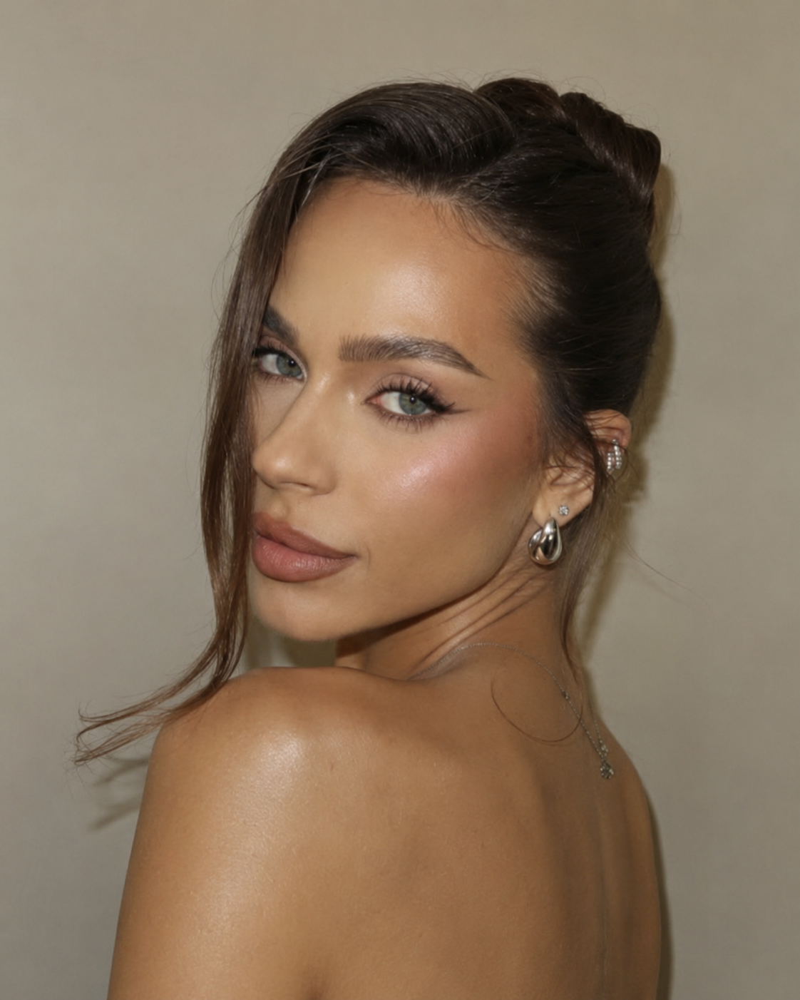 Glowing makeup and swept-up hairstyle